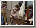 Elliot, dressed up like a mountain man, getting the experience of working with leather and tools.  I was a parent helper that day, helping 60 kids make bracelets.  I went home with a "pounding" headache!