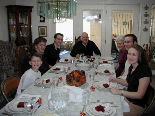 Here is the other half of the table, with a couple of smiling, but trying to be patient, repeats.  Please notice Wally's barbequed turkey in the center of the table.  How many of you have ever barbequed your Thanksgiving turkey?