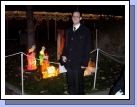 Elder Brown in front of the manger scene.  They did a great job at decorating with Christmas lights.