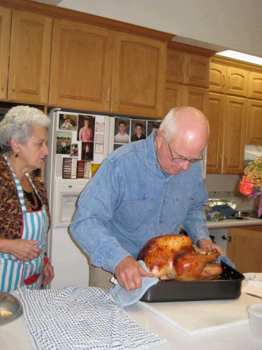 Grandma bringing in the masterpiece of the day -- barbequed turkey brined in salt and apple juice.  It was delicious!