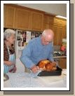 Grandma bringing in the masterpiece of the day -- barbequed turkey brined in salt and apple juice.  It was delicious!