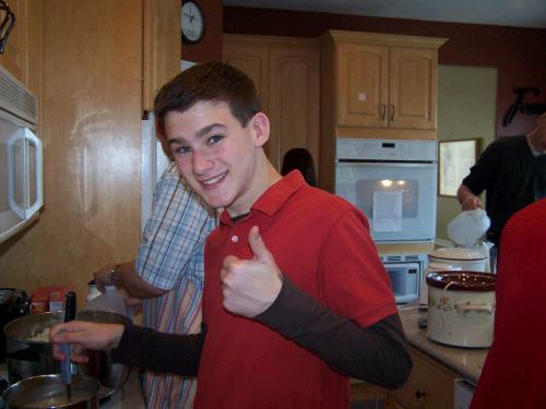 Elliot stirring gravy while Alan works on the mashed potatoes.