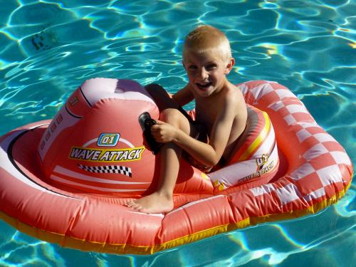 Jackson is the smart one who knew how to get on the floatie without getting wet!