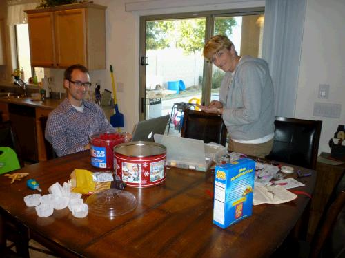 Keeping one eye on the game, Phillip had homework to do and Melinda fixed some jewelry for me.