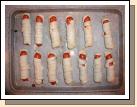 The hot dog mummies that Alan thought looked like two rows of hospital invalids.