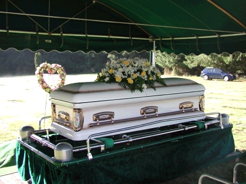 Grandma's beautiful casket with just a couple of flower arrangements.  She wanted things very simple.