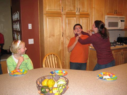 My daughter Madeleine trying to strangle my son Clark.  Hmmmm.....What a great example to the rest of the kids.