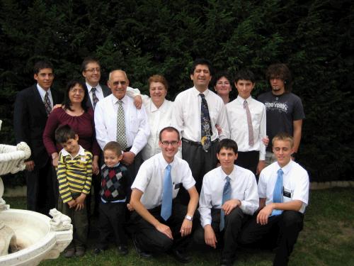 An Arjona family gathering for the birthday and ordination of their son Danny who turned 12 (second in from the right on back row). The matching ties are coincidental. Hermano Arjona is taking the picture and his wife is peeking out from the back. Their four sons are Samuel (oldest, far right), Reuben (in between us), Danny, and David (the clown in the striped shirt).