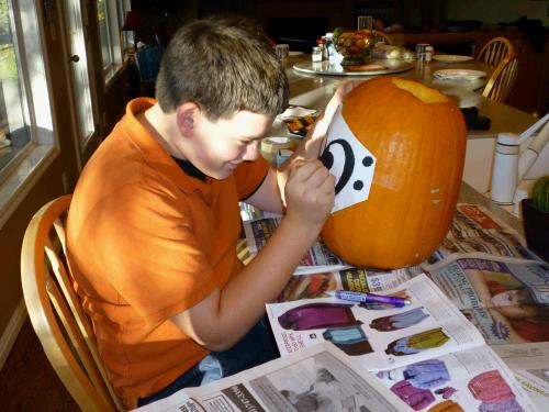 Transferring the pattern onto the pumpkin.