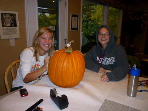 Some of Elliiot's school friends came over to carve, have dinner and go trick-or-treating together.  This is Natalie outlining her carving while Kylee looks on.